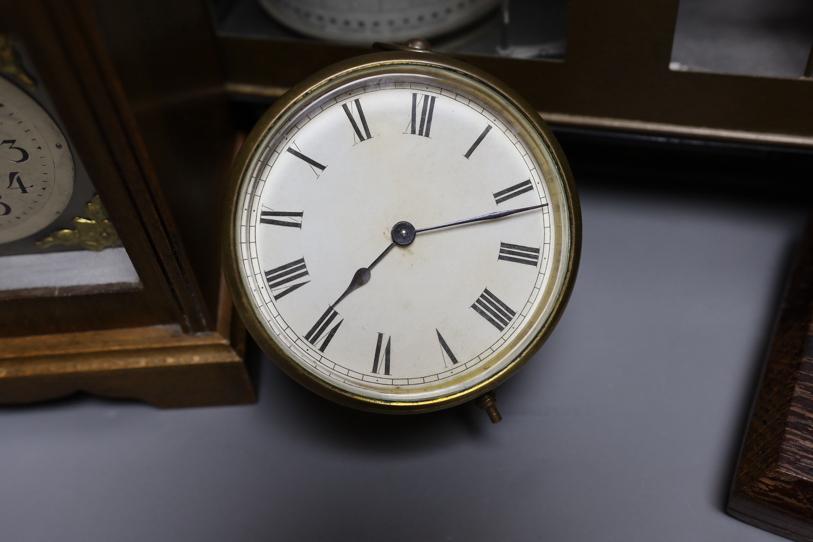 A barograph and three various time pieces including a carriage timepiece, a walnut bracket timepiece and a brass drum timepiece